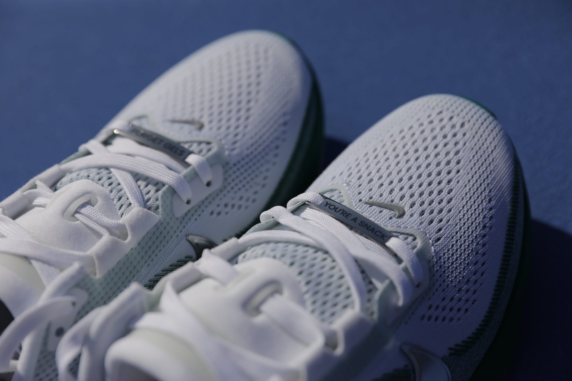 Runner tying laced shoes with engraved shoe tags